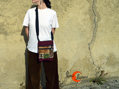 Bolso pequeño de bandolera de tela con bolsillos y cremalleras.