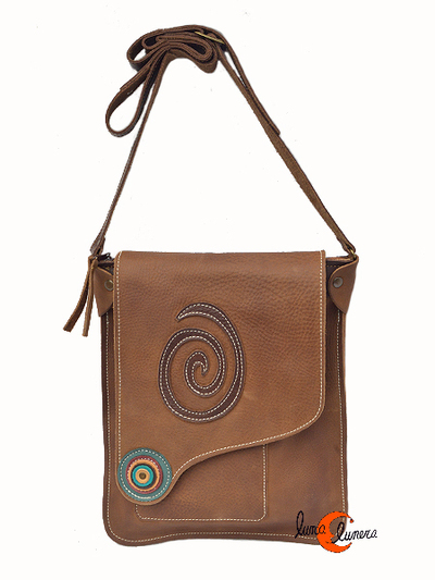 Bolso de piel del taller artesanal Arco Iris. Bolso plano asimétrico marrón rustico con adorno verde.